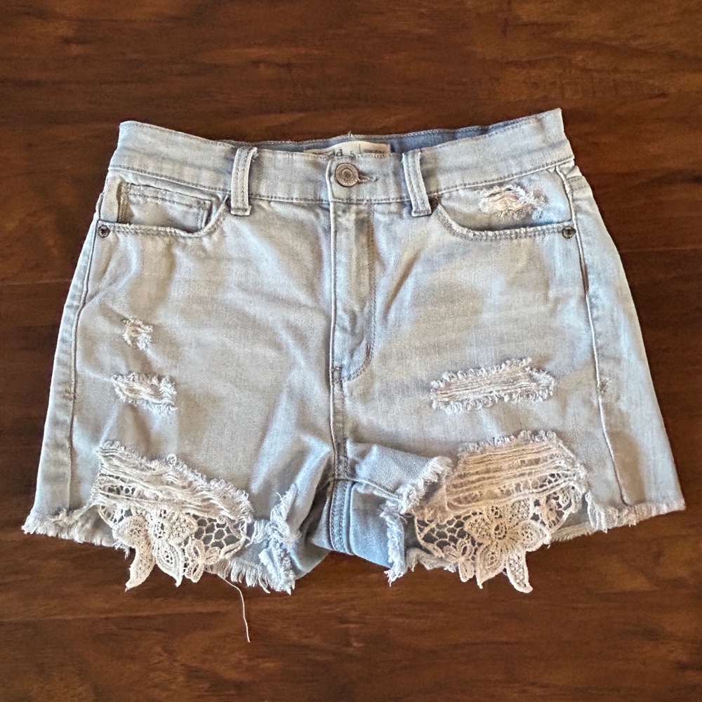 Light wash jean shorts with lace pockets